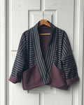 Striped Haori kimono jacket with cotton lining in black and grey stripes and aubergine colors. This jacket has large pockets on the front. Made by Atelier Heimat, handcrafted by Kachiri Faes.